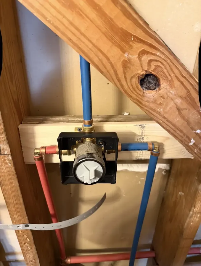 Shower valve roughed in with new red and blue PEX supply lines between wall studs
