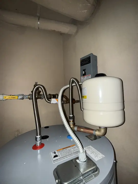 Expansion tank and flexible stainless water connectors on top of a water heater