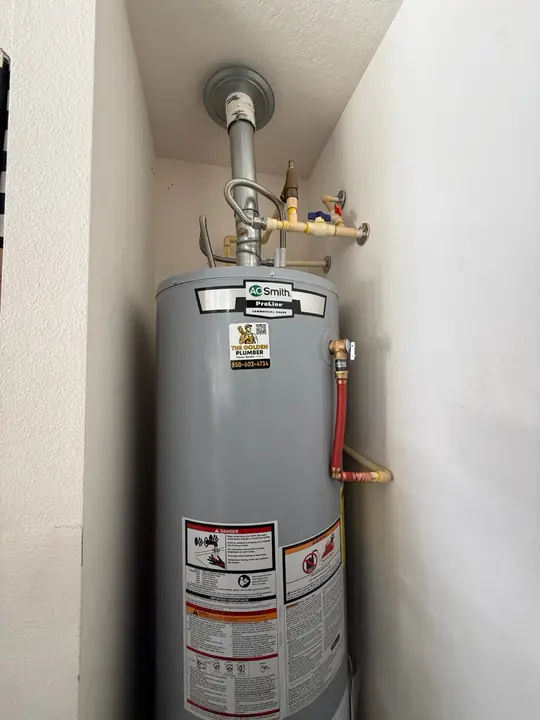New A. O. Smith gas water heater with vent pipe and gas line in a closet