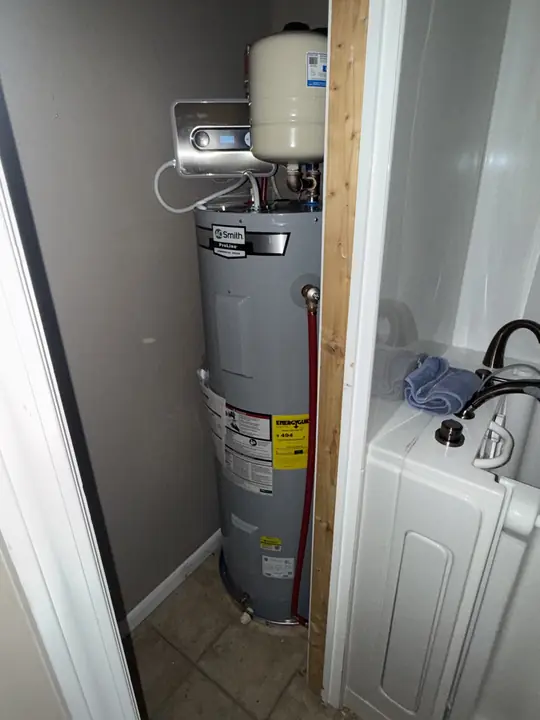 A. O. Smith electric water heater with expansion tank in a narrow utility closet