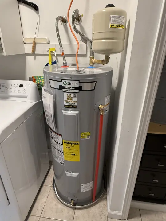 New A. O. Smith ProLine electric water heater with expansion tank in a laundry room