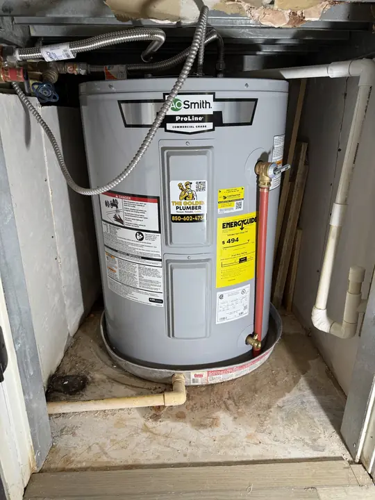 Compact A. O. Smith ProLine electric water heater with drain pan in a low cabinet