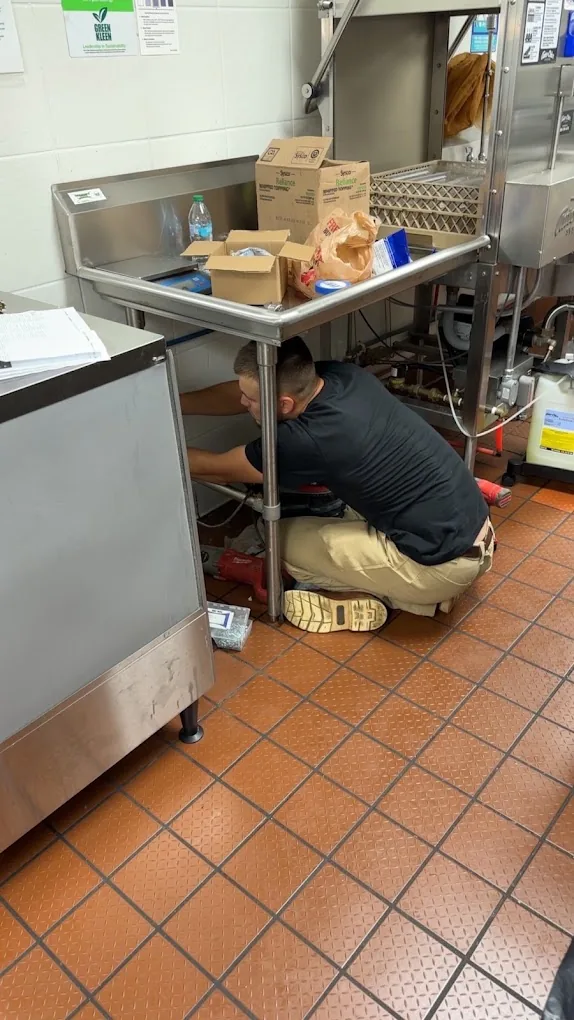 Commercial kitchen plumbing repair under a dish station in Pensacola